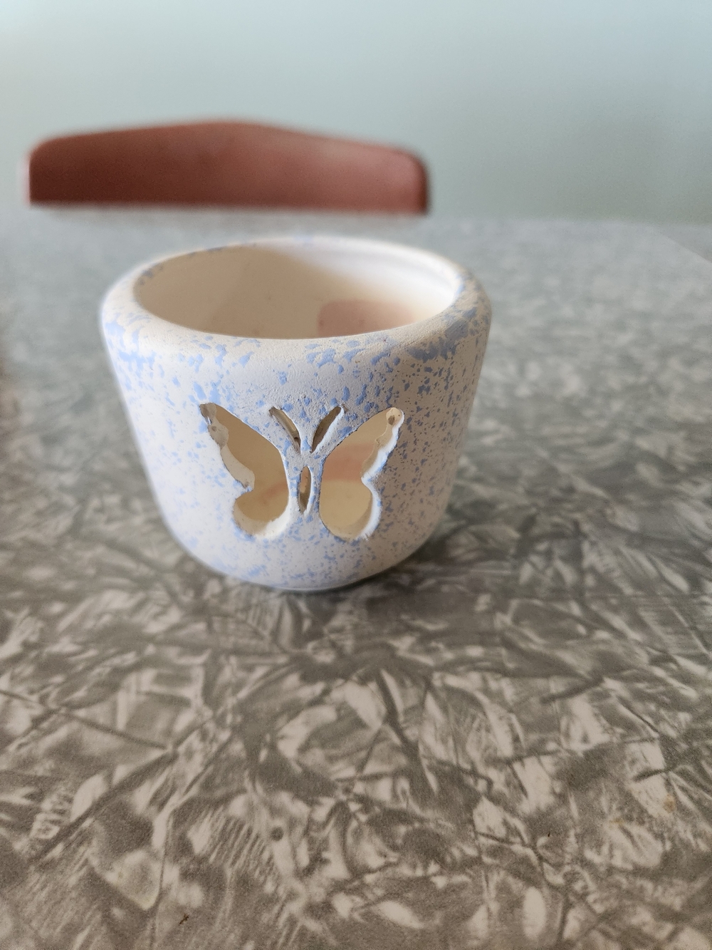 Source Unknown White Ceramic Candle Holder with Blue Speckle & Butterfly Cutout